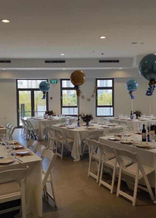 שולחנות ערוכים עם בלונים לעלייה לתורה